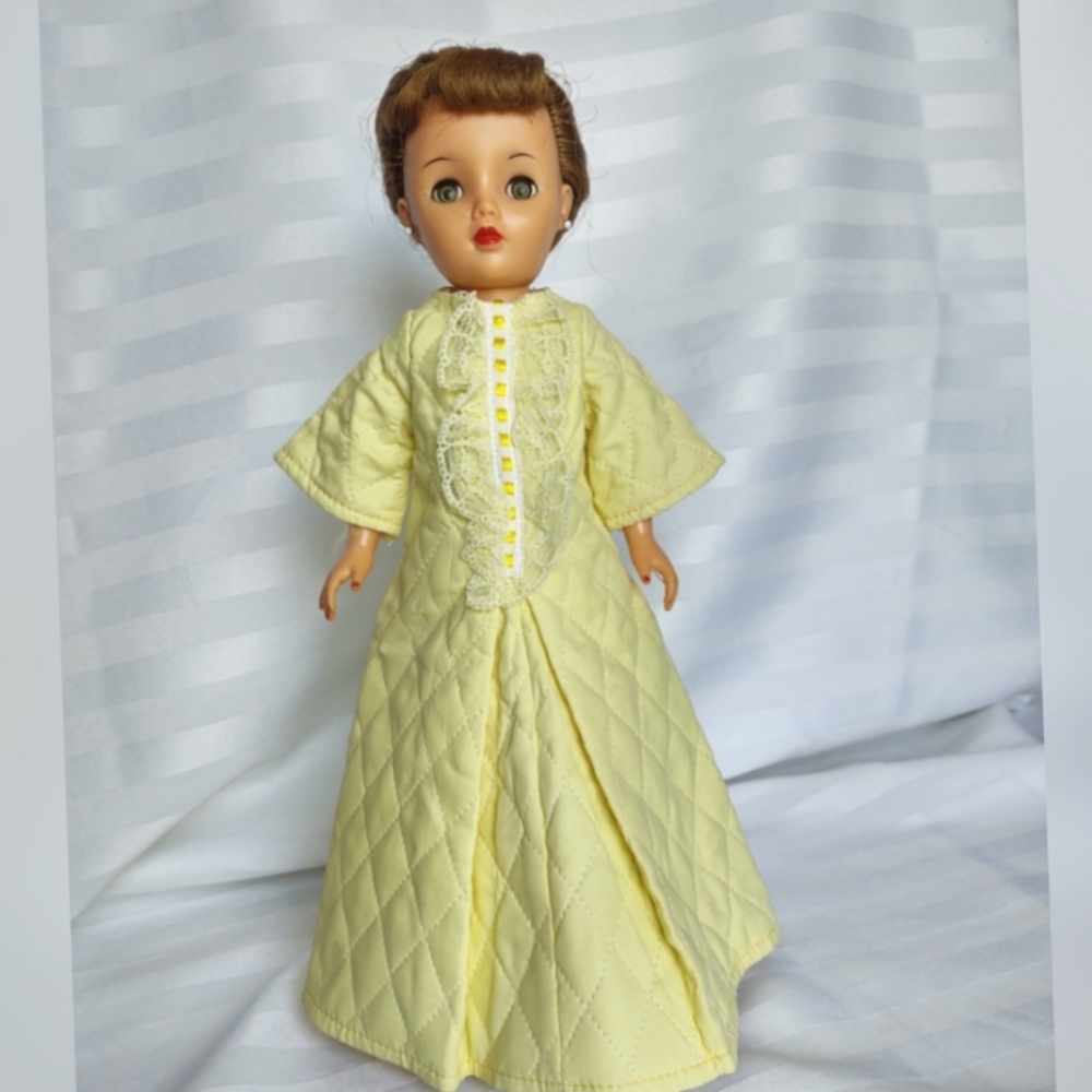 15" Miss Revlon doll wearing a yellow housecoat, hose and heels